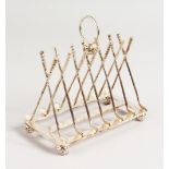 A NOVELTY SIX DIVISION GOLF TOAST RACK with crossed clubs and balls.