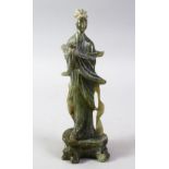 A GOOD 20TH CENTURY JADE / JADE LIKE CARVING OF GUANYIN, stood upon a base, holding a rabbit /