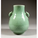 A CHINESE CELADON GROUND TWIN HANDLE PORCELAIN VASE, the vase with carved decortation in formal