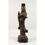 A LARGE 19TH / 20TH CENTURY CHINESE CARVED WOODEN FIGURE OF GUANYIN, stood holding her ruyi