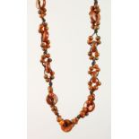 A CHINESE RHINO HORN BEAD NECKLACE, comprising fifteen disks, interspaced with small horn beads,