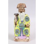 A 18TH CENTURY CHINESE FAMILLE ROSE PORCELAIN FIGURE OF AN IMMORTAL, wearing traditional attire,