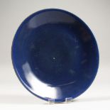 AN EARLY 19TH CENTURY CHINESE PROVINCIAL POWDER BLUE PORCELAIN DISH, the base with a stylised