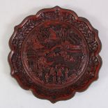 A VERY GOOD QUALITY CHINESE QING DYNASTY CINNABAR LACQUER DISH, the dish deeply carved to depict