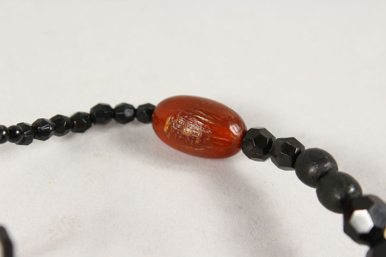 A GOOD CHINESE RHINO HORN BEAD NECKLACE, with nine oval beads of various size, interspaced with a - Image 6 of 6