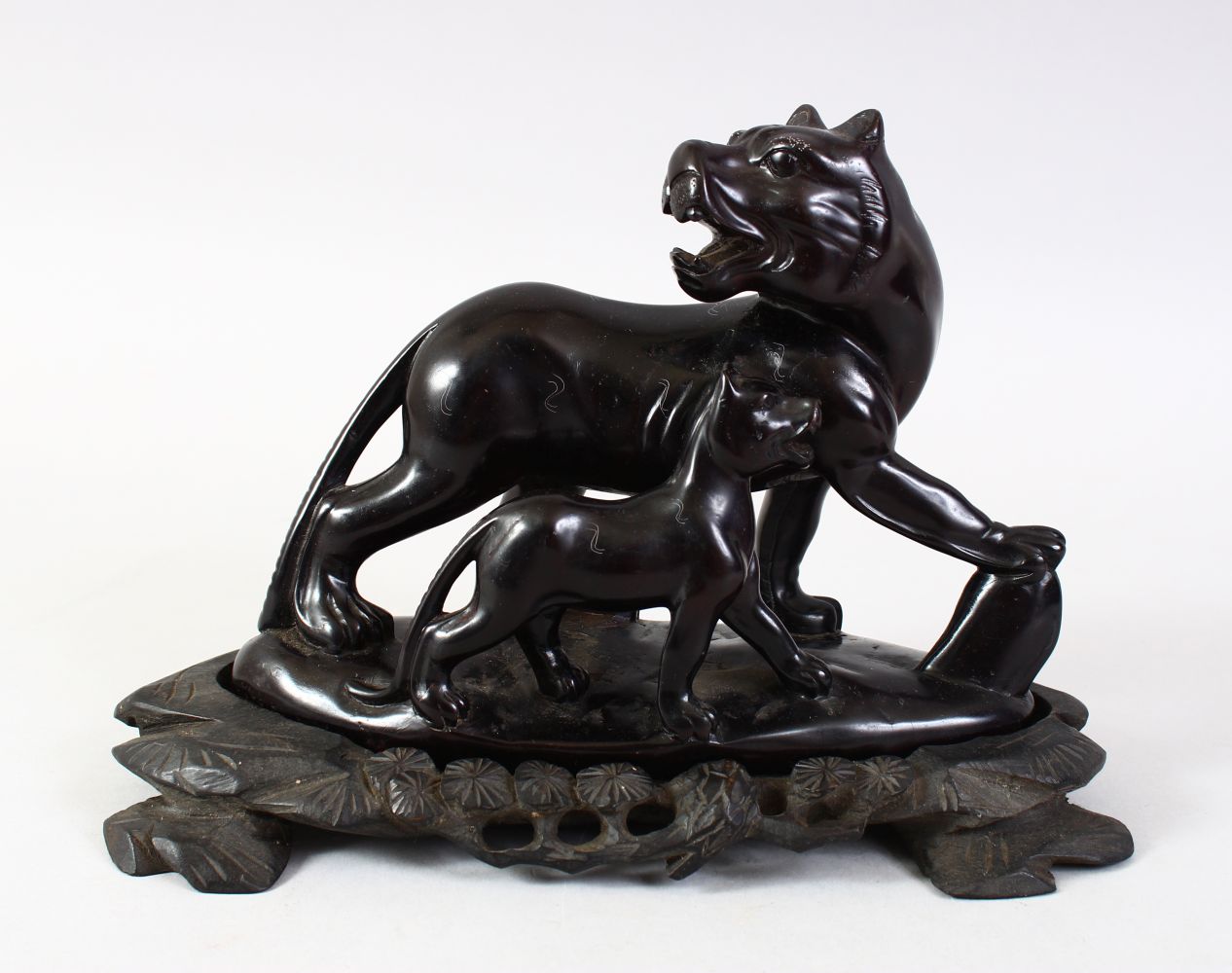 AN UNUSUAL CHINESE CARVED OBSIDIAN STONE FIGURE OF TWO KYLIN. the carved stone figure depicting