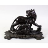 AN UNUSUAL CHINESE CARVED OBSIDIAN STONE FIGURE OF TWO KYLIN. the carved stone figure depicting