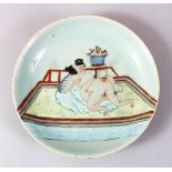 A GOOD 19TH CENTURY CHINESE CELADON FAMILLE ROSE PORCELAIN EROTIC DISH, the celadon ground with