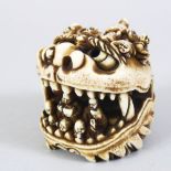 A JAPANESE MEIJI PERIOD CARVED IVORY OKIMONO / NETSUKE OF A SHI SHI DOG, the large model dog with