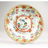 A LARGE 18TH CENTURY CHINESE FAMILLE ROSE PORCELAIN DISH, the dish decorated with scenes of native