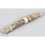 A GOOD JAPANESE MEIJI PERIOD CARVED IVORY TANTO, the case carved sectional to depict scenes of
