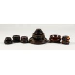 A MIXED LOT OF THIRTEEN CARVED HARDOOD STANDS, from 13.5cm diameter down to 4cm. (13)