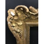 19th Century French School. A Carved Giltwood Frame, with swept corners, 39.5" x 32" (rebate).