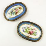 PAIR OF CURVED OVAL SHAPED PORCELAIN PANELS FLORAL DECORATION, POSSIBLY COALPORT, EACH HAVING A GILT