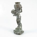 CAST FIGURE OF A CHERUB BEARING A GRECIAN URN, AUG MOREAU