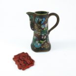 CLOISONNÉ JUG AND A CINNABAR RED LACQUER ORIENTAL MEDALLION