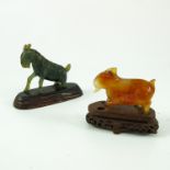 2 GOAT FIGURES, EACH ON A WOODEN STAND, ONE GREEN STONE, JADEITE? THE OTHER AMBER STONE AF LARGEST