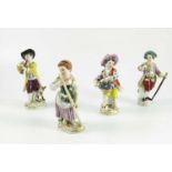 4 VARIOUS CONTINENTAL FIGURES, 3 GENTLEMEN AND A LADY WITH A RAKE, TALLEST APPROX. 14 cm, EACH