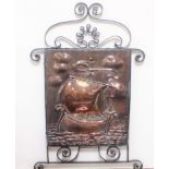 ARTS AND CRAFTS STYLE WROUGHT IRON FRAMED COPPER SCREEN DECORATED WITH A GALLEON ON FULL SAIL, IN
