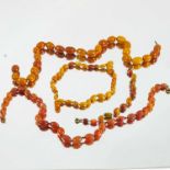 4 STRINGS OF AMBER BEADS, LARGEST BEAD APPROX. 17 X 12 mm