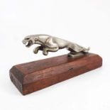 JAGUAR CAR MASCOT MOUNTED ON A WOODEN PLINTH, APPROX. 20cm L.