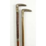 2 CONTINENTAL LADIES WALKING STICKS EACH HAVING A WHITE METAL HANDLE AND INSCRIBED BANDS