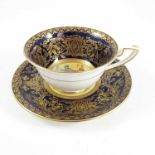 ROYAL WORCESTER CABINET CUP AND SAUCER BLUE AND GILT WITH FLOWER DECORATION SIG E BARKER