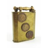 AN EARLY 20TH CENTURY FRENCH TABLE LIGHTER WITH LATER APPLIED COINS