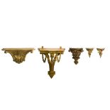 Five carved and giltwood wall mounted brackets