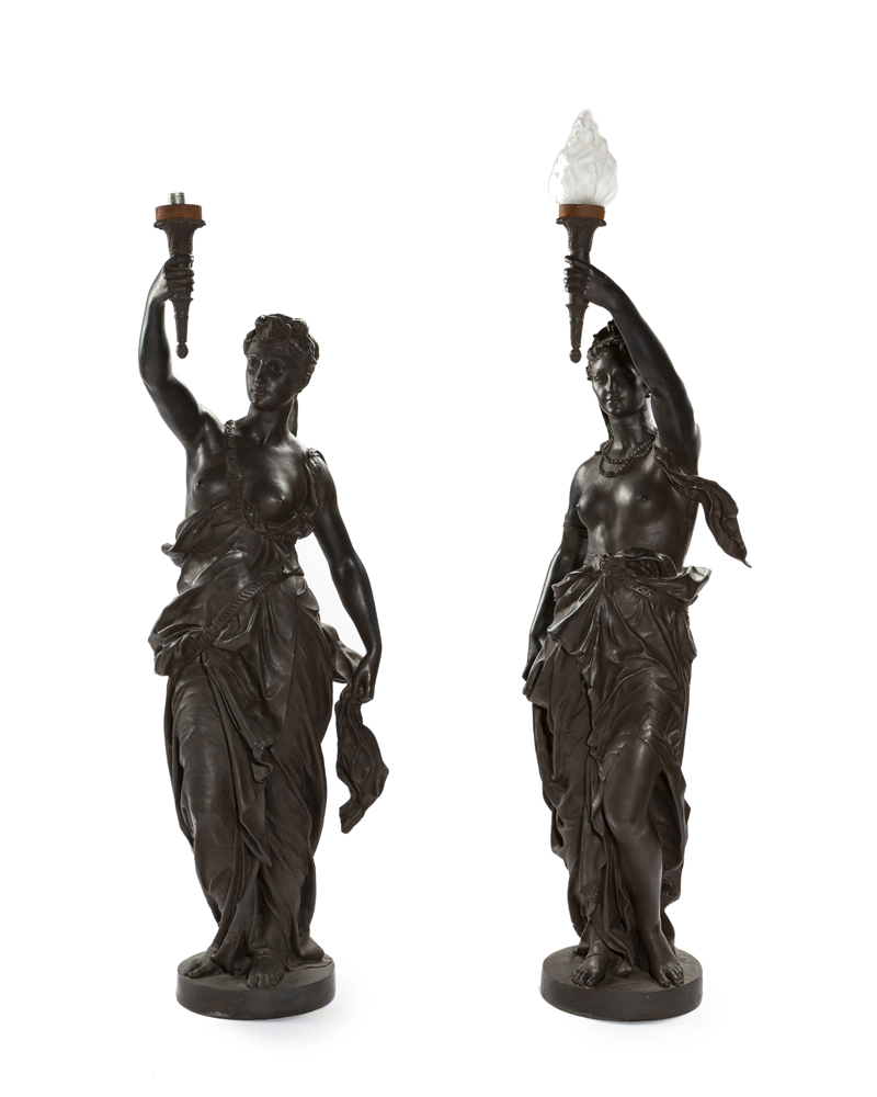 A pair of patinated figural torchières