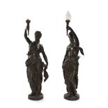 A pair of patinated figural torchières