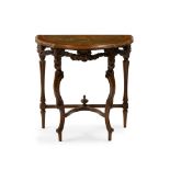 A diminutive carved wood demi-lune table