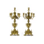 A pair of patinated metal candelabras