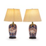 A pair of polychrome Imari lamps