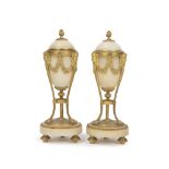 A pair of French gilt bronze-mounted alabaster convertible urns