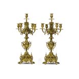 A pair of patinated metal candelabras