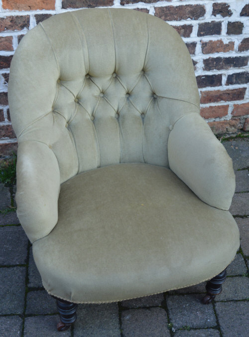 Victorian button back armchair on turned legs with casters