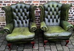 Pair of leather button back winged armchairs.