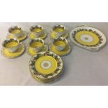 Yellow ground & figural half tea service comprising cups, saucers,