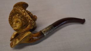 A meerschaum pipe in the form of a ladies head with a silver collar