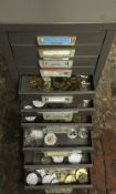 Small filling cabinet containing mainly pocket watch parts.