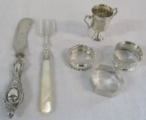 3 silver napkin rings weight 1.03 ozt, a small silver cup 1.