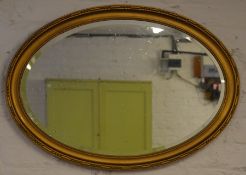 Gilt framed oval wall mirror