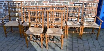 8 (inc. 2 carvers) reproduction 18th century ladder back oak dining chairs with rush seats
