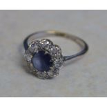 18ct gold daisy ring (previously white plated) set with central eight cut sapphire surrounded by