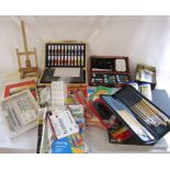 Large collection of painting materials inc brushes, canvasses, paints and an easel