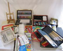 Large collection of painting materials inc brushes, canvasses, paints and an easel