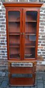 Glass fronted bookcase on stand