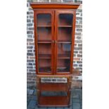 Glass fronted bookcase on stand