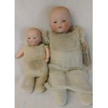 2 Armand Marseille bisque head dolls with cloth bodies height 32cm and 29cm